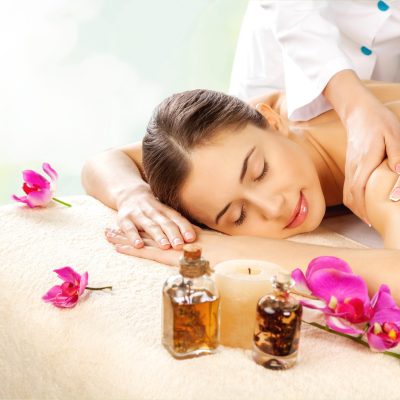 Beautiful young woman relaxing with massage at beauty spa